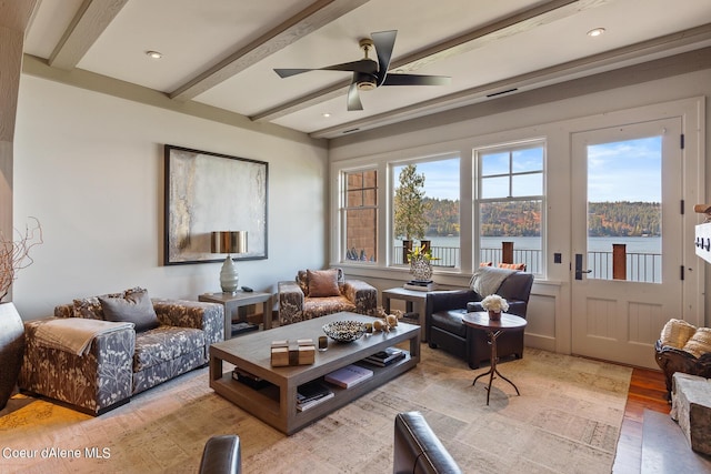 living area featuring light wood-type flooring, a ceiling fan, beam ceiling, and recessed lighting