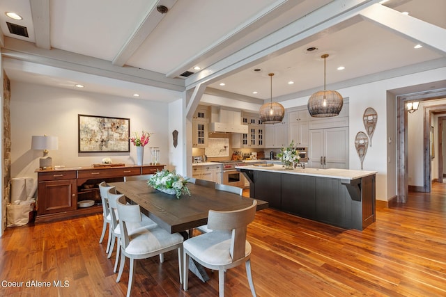 dining room featuring recessed lighting, visible vents, beamed ceiling, and wood finished floors