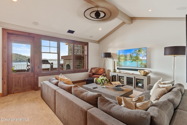 living area featuring visible vents, baseboards, light colored carpet, vaulted ceiling with beams, and a fireplace