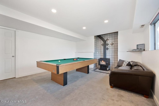 playroom with light carpet, visible vents, recessed lighting, and a wood stove