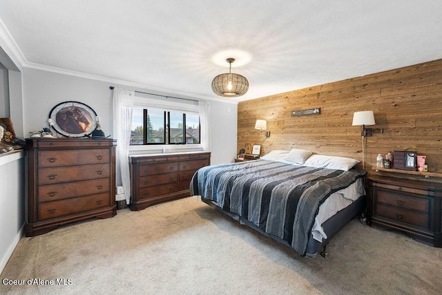 bedroom featuring wood walls, carpet flooring, and crown molding