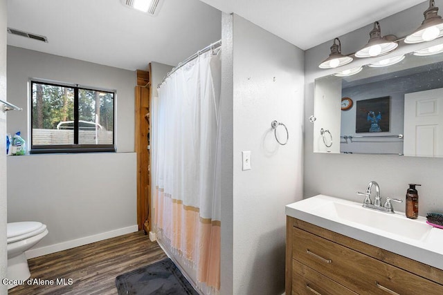 full bathroom featuring visible vents, baseboards, toilet, and wood finished floors