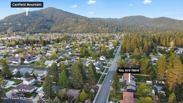 bird's eye view with a wooded view, a mountain view, and a residential view