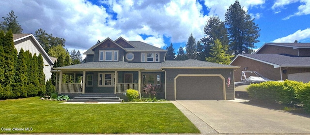 505 S Shore Pines Rd, Post Falls, ID 83854 - view of front of house with a porch, a garage, concrete driveway, a front lawn, and roof with shingles