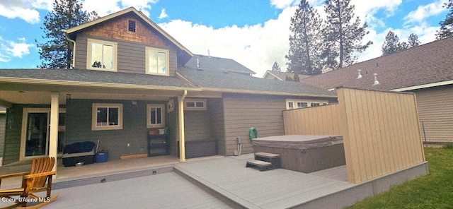 505 S Shore Pines Rd, Post Falls, ID 83854 - back of property with a hot tub, a patio, and roof with shingles