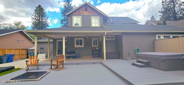 505 S Shore Pines Rd, Post Falls, ID 83854 - rear view of house featuring a hot tub, a wooden deck, and a patio area
