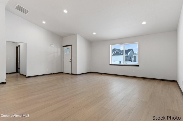 spare room with light wood-type flooring, baseboards, visible vents, and recessed lighting