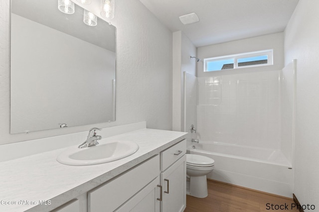 bathroom with vanity, tub / shower combination, wood finished floors, and toilet