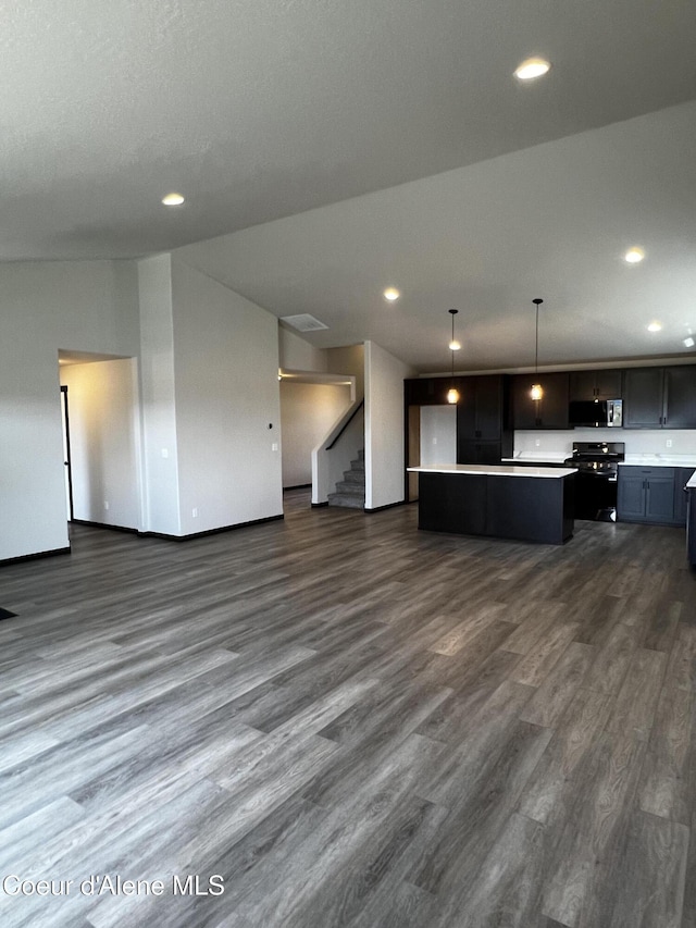 11557 N Railway Ave, Rathdrum, ID 83858 - unfurnished living room featuring dark wood finished floors, recessed lighting, and stairway