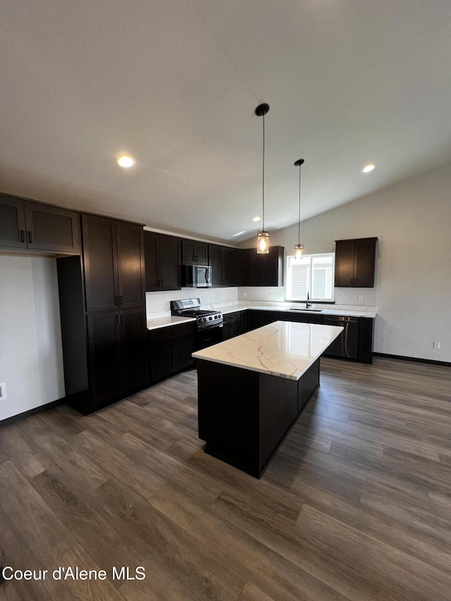 11557 N Railway Ave, Rathdrum, ID 83858 - kitchen with stainless steel microwave, gas range oven, vaulted ceiling, a center island, and dark wood-style floors