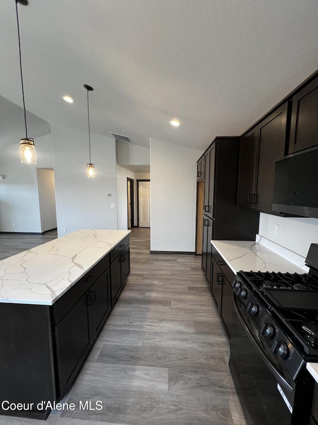 11557 N Railway Ave, Rathdrum, ID 83858 - kitchen with black gas range, a center island, light stone countertops, decorative light fixtures, and recessed lighting