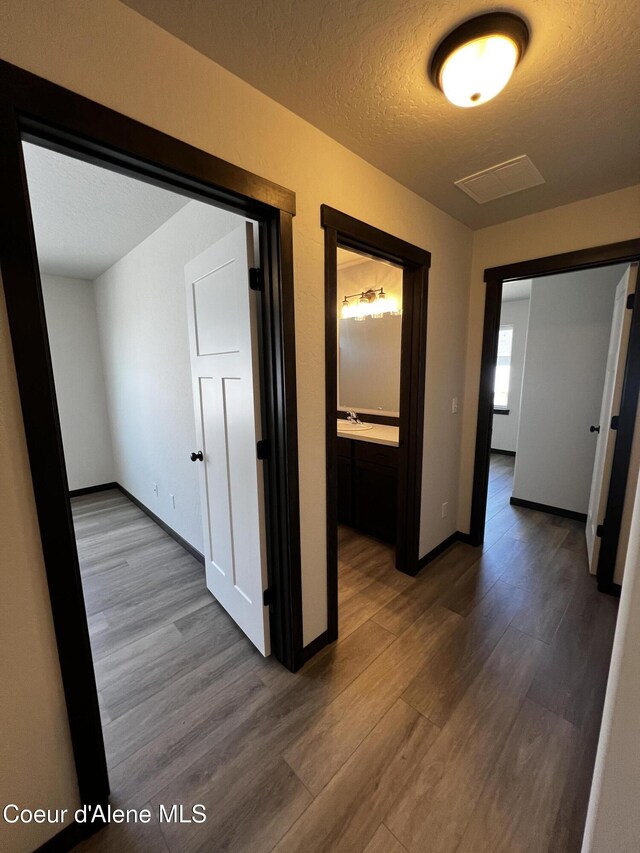 11557 N Railway Ave, Rathdrum, ID 83858 - hallway featuring wood finished floors and a textured ceiling