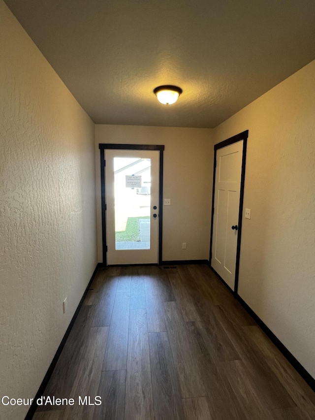 11557 N Railway Ave, Rathdrum, ID 83858 - empty room with dark wood-style floors and a textured wall