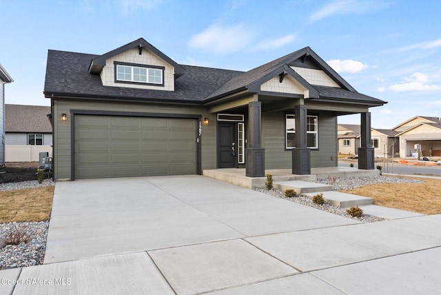 view of front of property with an attached garage, covered porch, concrete driveway, and roof with shingles