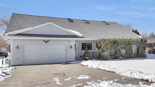 view of front of property featuring driveway, a shingled roof, and an attached garage