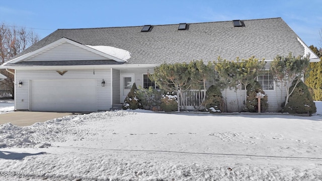 view of front of house featuring a garage and roof with shingles