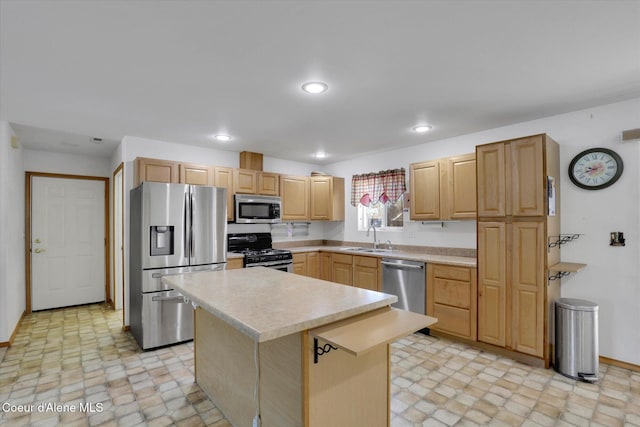 kitchen featuring stainless steel appliances, a sink, light countertops, and recessed lighting