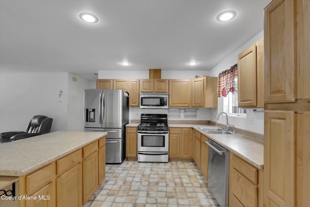 kitchen featuring light brown cabinets, recessed lighting, a sink, light countertops, and appliances with stainless steel finishes