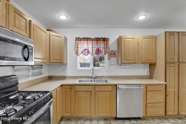 kitchen with stainless steel appliances, light countertops, light brown cabinets, and a sink