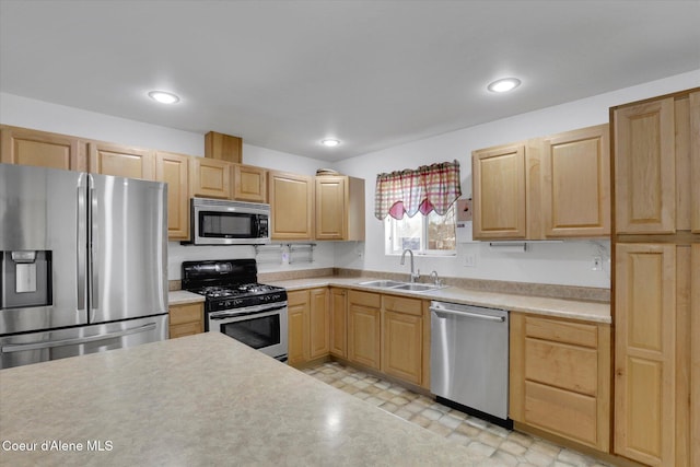 kitchen featuring a sink, stainless steel appliances, and light brown cabinets