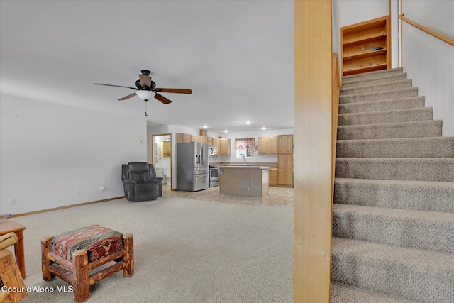 living room with ceiling fan, recessed lighting, light colored carpet, baseboards, and stairway