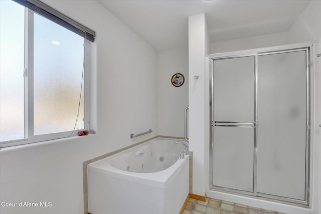 full bath featuring a stall shower and a jetted tub