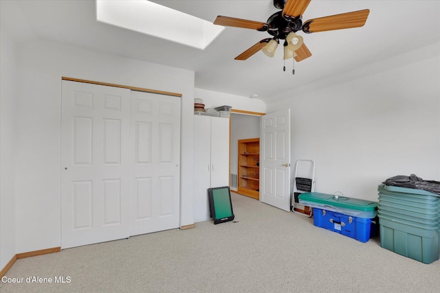 interior space featuring a ceiling fan and carpet flooring