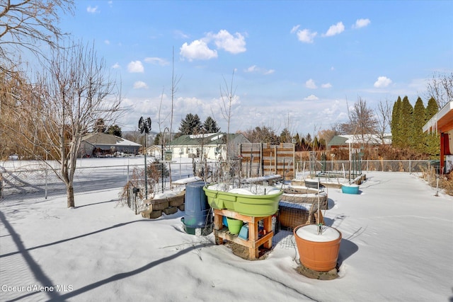 yard layered in snow with fence