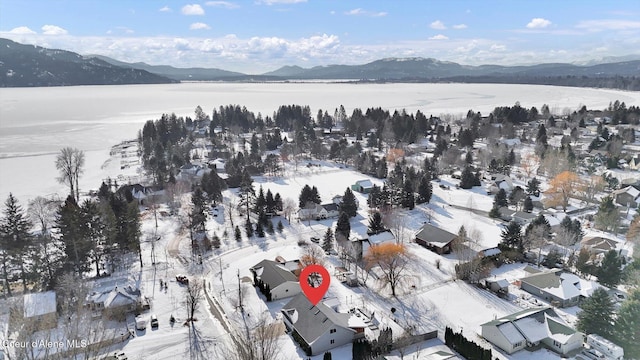 birds eye view of property featuring a water and mountain view