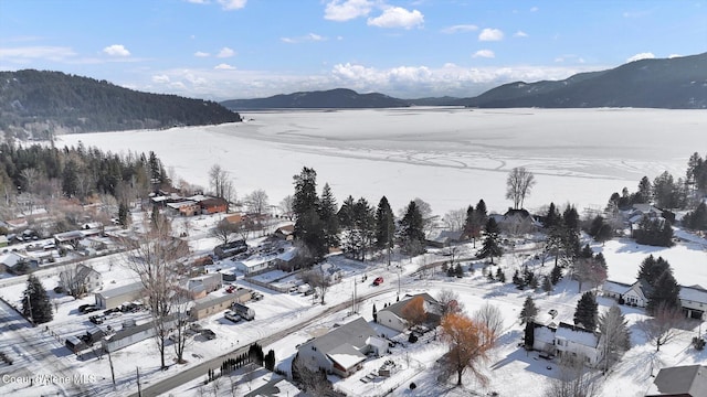 snowy aerial view with a mountain view