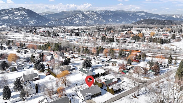 snowy aerial view featuring a mountain view