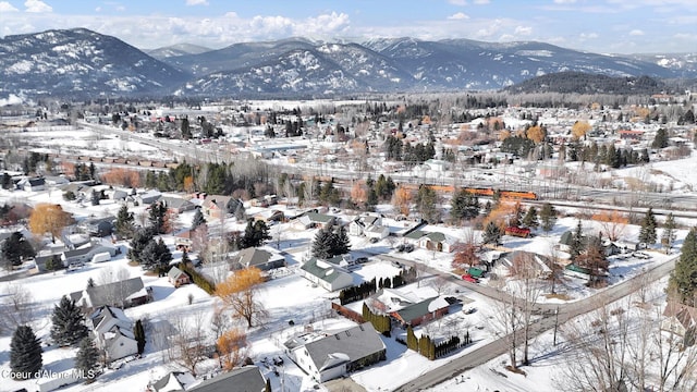 snowy aerial view with a mountain view