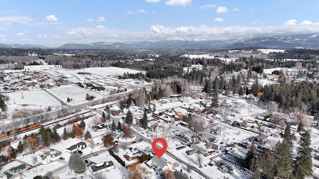 snowy aerial view featuring a mountain view