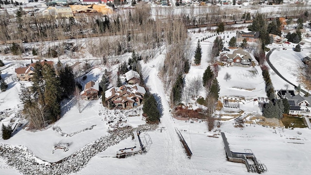 snowy aerial view with a residential view