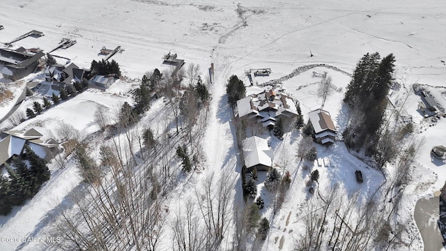 snowy aerial view with a residential view