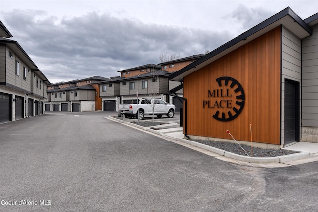 view of road featuring a residential view and curbs