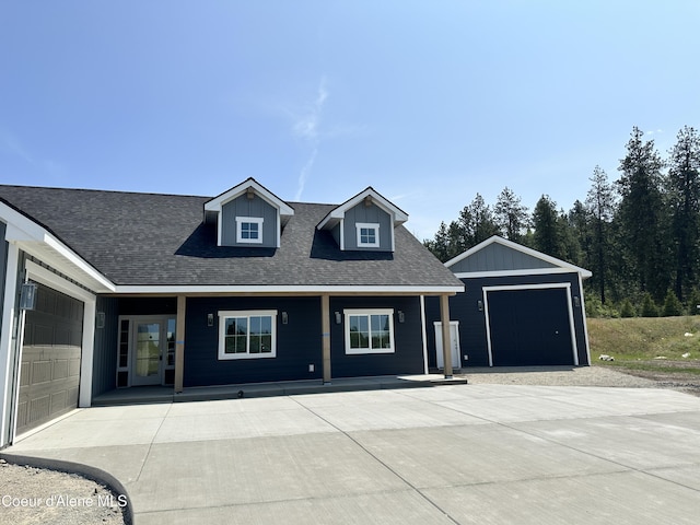 4550 E Savea Ln, Post Falls, ID 83854 - view of front of property featuring a garage, roof with shingles, and covered porch
