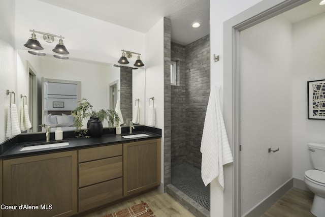 4550 E Savea Ln, Post Falls, ID 83854 - full bath featuring tiled shower, wood finished floors, and double vanity