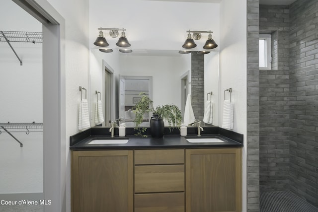 4550 E Savea Ln, Post Falls, ID 83854 - bathroom with double vanity, a spacious closet, and tiled shower
