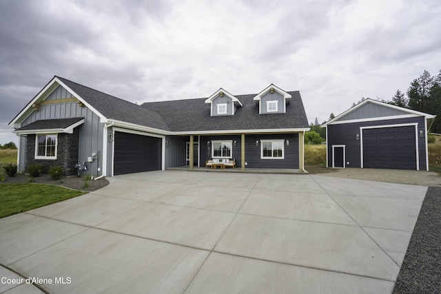 4550 E Savea Ln, Post Falls, ID 83854 - view of front of home featuring board and batten siding, roof with shingles, and driveway