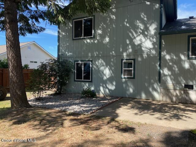 rear view of property with a patio and fence