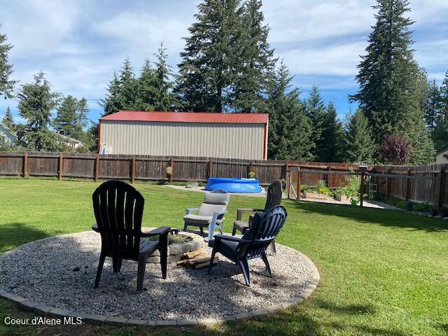 view of yard with a patio, a fenced backyard, and a fenced in pool