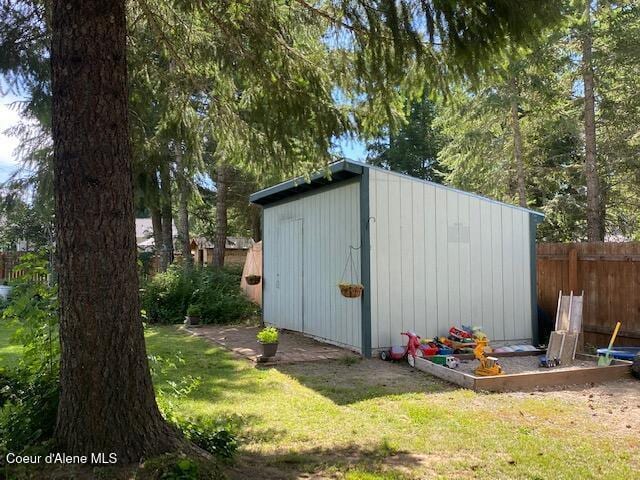 view of shed with fence