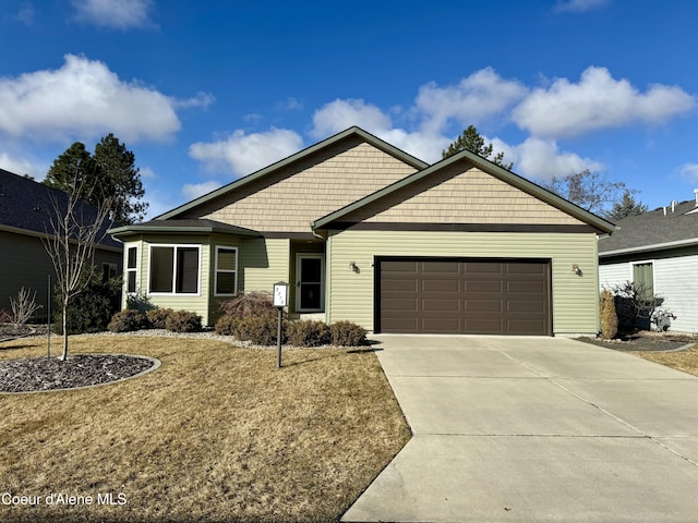 view of front of property featuring concrete driveway and an attached garage