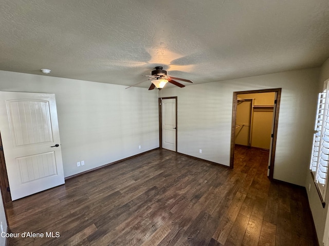 unfurnished bedroom with a closet, dark wood finished floors, and a textured ceiling