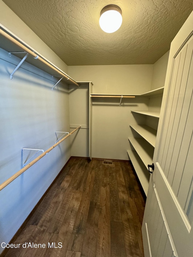 spacious closet with wood finished floors