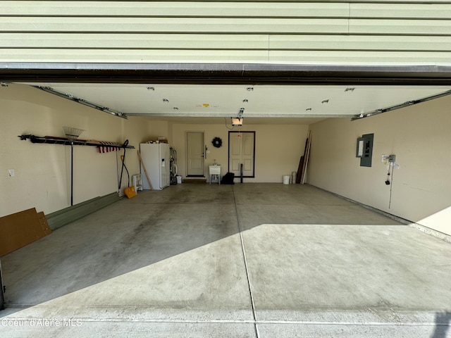 garage with electric panel and a garage door opener