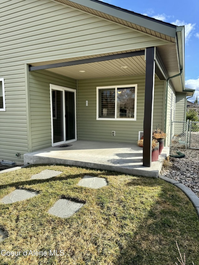 back of property featuring a patio and fence