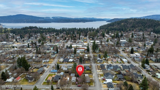 drone / aerial view featuring a water and mountain view