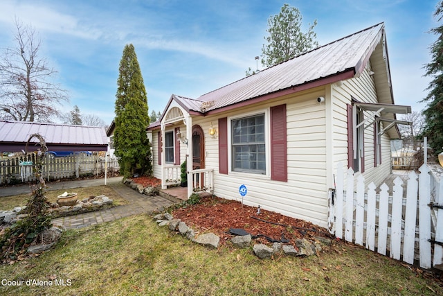 bungalow with fence and metal roof